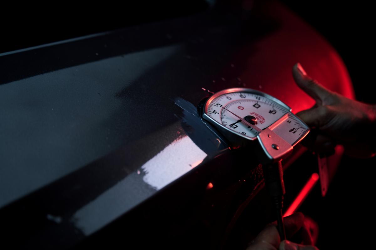 Paint thickness gauge measuring a repaired body panel