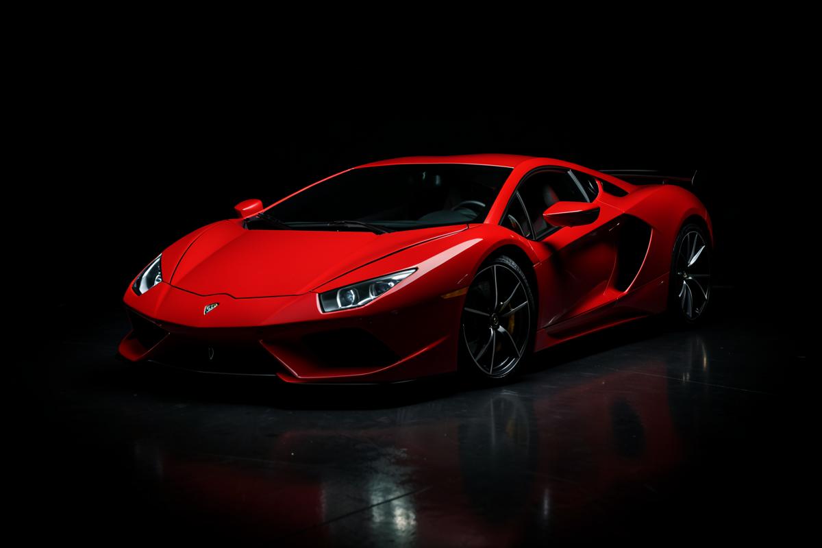 Red exotic supercar photographed in a dark studio with rim lighting